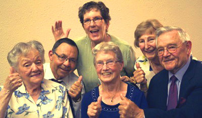 a group of seniors waving at the camera