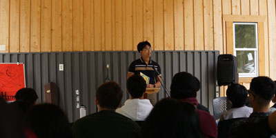 a man preaching to a group of youth